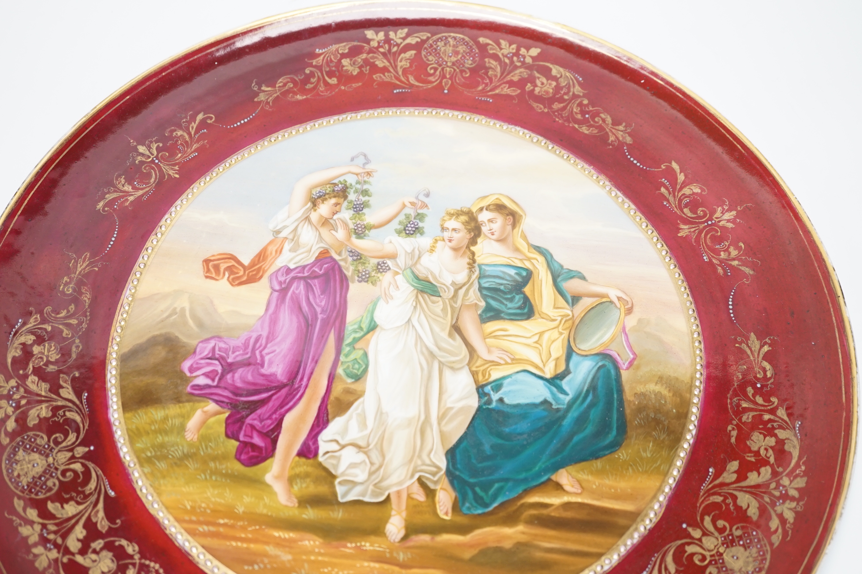 A Vienna style red porcelain charger, 40cm diameter